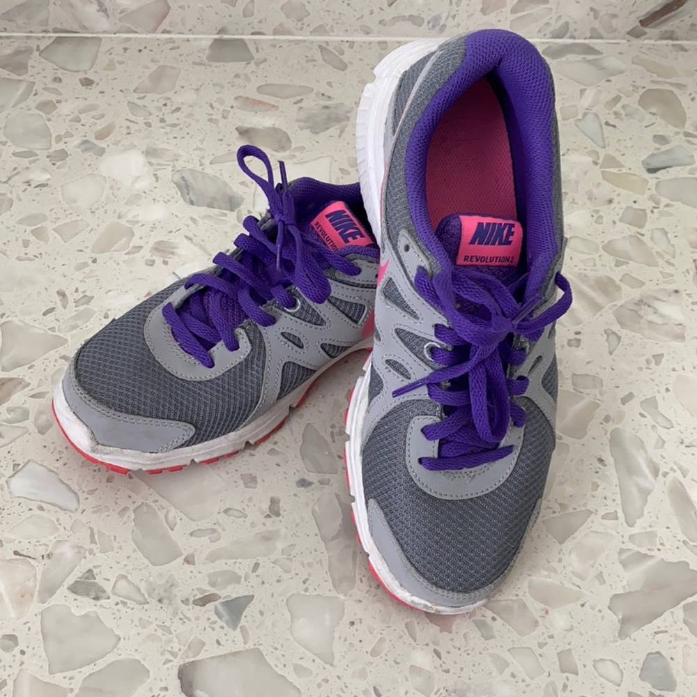 Nike pink, purple, and gray shoes